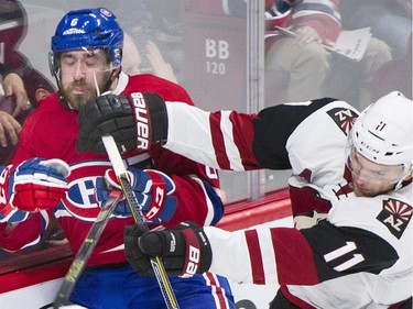 Arizona Coyotes' Martin Hanzal (11) checks Montreal Canadiens' Greg Pateryn into the boards during second period NHL hockey action in Montreal, Thursday, November 19, 2015.