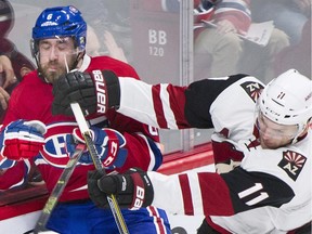 Coyotes' Martin Hanzal checks Canadiens' Greg Pateryn into the boards during second period NHL hockey action in Montreal, Thursday, November 19, 2015.