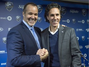 Montreal Impact president Joey Saputo, left, shakes hands with Mauro Biello after being confirmed as head coach during a news conference Friday, November 13, 2015 in Montreal.