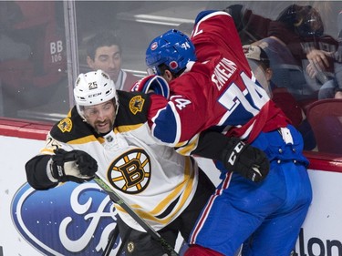 Boston Bruins' Max Talbot, left, fends off Montreal Canadiens' Alexei Emelin during first period NHL hockey action, in Montreal, on Saturday, Nov. 7, 2015.
