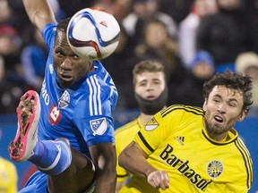 Montreal Impact's Didier Drogba, left, challenges Columbus Crew SC's Michael Parkhurst during first half first leg MLS playoff soccer action in Montreal, Sunday, Nove.1, 2015.