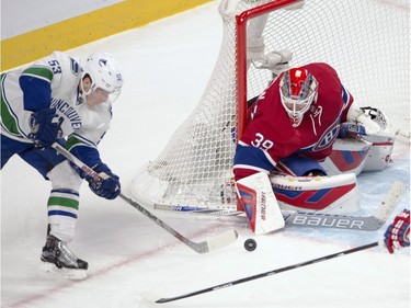 Montreal Canadiens goalie Mike Condon (39) makes a save against Vancouver Canucks center Bo Horvat (53) during second period National Hockey League action Monday, November 16, 2015 in Montreal.