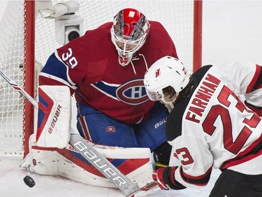 Montreal Canadiens' goaltender Mike Condon (39) makes a save against New Jersey Devils' Bobby Farnham during second period NHL hockey action, in Montreal, on Saturday, Nov. 28, 2015.