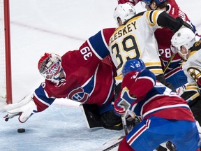 Montreal Canadiens' goalie Mike Condon (39) snags a loose puck just in time as the Canadiens face the Boston Bruins during second period NHL hockey action, in Montreal, on Saturday, Nov. 7, 2015.
