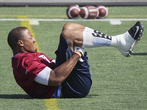 Montreal Alouettes defensive end John Bowman stretches during practice in Montreal Monday August 24, 2015.