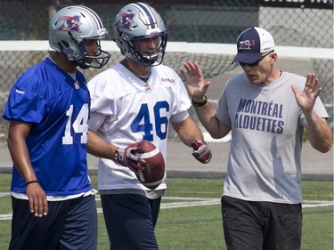 Montreal Alouettes head coach Tom Higgins, right, with Boris Bede, 14, and Jean-Christophe Beaulieu, during morning practice in Montreal on Tuesday August 18, 2015. The Alouettes play the BC Lions on Thursday August 20, 2015 in Vancouver.