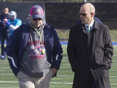 Montreal Alouettes President and CEO Mark Weightman, right, speaks with head coach Jim Popp  during Alouettes practice on Wednesday October 21, 2015.