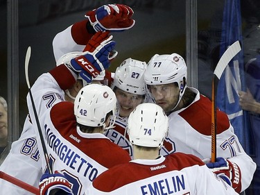 Montreal Canadiens centre Alex Galchenyuk (27) celebrates with teammates after scoring a goal against the New York Rangers during the third period of an NHL hockey game Wednesday, Nov. 25, 2015, in New York. The Canadiens won 5-1.