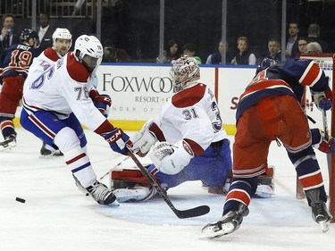Montreal Canadiens goalie Carey Price (31) blocks a shot attempt by New York Rangers center Oscar Lindberg (24) as Canadiens defenseman P.K. Subban (76) looks for the rebound during the second period of an NHL hockey game Wednesday, Nov. 25, 2015, in New York.