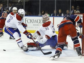 Montreal Canadiens goalie Carey Price (31) blocks a shot attempt by New York Rangers centre Oscar Lindberg (24) as Canadiens defenceman P.K. Subban (76) looks for the rebound during the second period of an NHL hockey game Wednesday, Nov. 25, 2015, in New York.