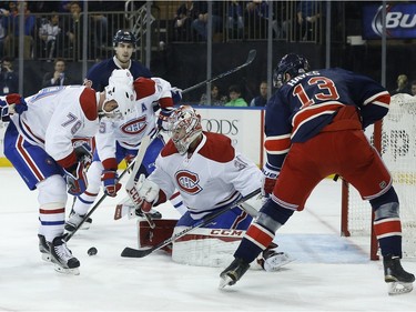 Montreal Canadiens goalie Carey Price (31) blocks a shot by New York Rangers right wing Kevin Hayes (13) as Canadiens defenceman Andrei Markov (79) looks for a rebound during the second period of an NHL hockey game, Wednesday, Nov. 25, 2015, in New York. The Canadiens won 5-1.