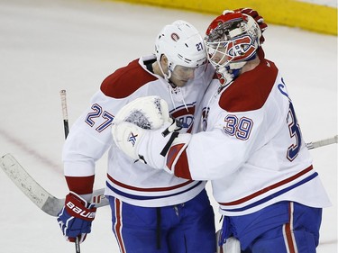Montreal Canadiens goalie Mike Condon (39) greets centre Alex Galchenyuk (27) after the Canadiens defeated the New York Rangers 5-1 in an NHL hockey game Wednesday, Nov. 25, 2015, in New York.