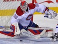 Canadien rookie Mike Condon makes a save against the Calgary Flames during NHL hockey in Calgary on Friday October 30, 2015.