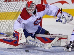 Canadien rookie Mike Condon makes a save against the Calgary Flames during NHL hockey in Calgary on Friday October 30, 2015.