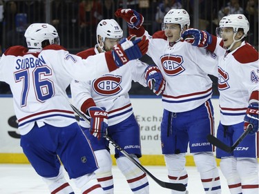 Montreal Canadiens right wing Sven Andrighetto (42) celebrates with teammates after scoring a goal against the New York Rangers during the first period of an NHL hockey game, Wednesday, Nov. 25, 2015, in New York.