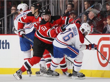 Sergey Kalinin #51 of the New Jersey Devils gets the stick up on P.K. Subban #76 of the Montreal Canadiens during the second period at the Prudential Center on November 27, 2015 in Newark, New Jersey.