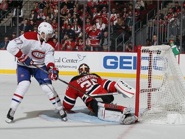 Alex Galchenyuk #27 of the Montreal Canadiens scores a shootout goal against Cory Schneider #35 of the New Jersey Devils at the Prudential Center on November 27, 2015 in Newark, New Jersey. The Canadiens defeated the Devils 3-2 in the shootout.