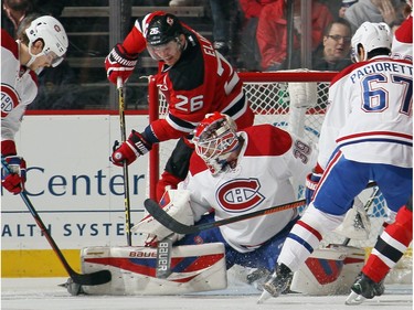 Patrik Elias #26 of the New Jersey Devils gets in behind Mike Condon #39 of the Montreal Canadiens during the first period at the Prudential Center on November 27, 2015 in Newark, New Jersey.