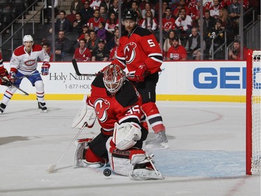 Cory Schneider #35 of the New Jersey Devils makes the first period save on David Desharnais #51 of the Montreal Canadiens at the Prudential Center on November 27, 2015 in Newark, New Jersey.