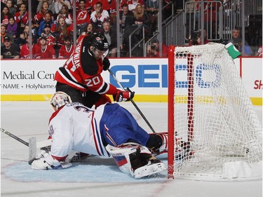 Lee Stempniak #20 of the New Jersey Devils scores a power-play goal at 9:06 of the second period against Mike Condon #39 of the Montreal Canadiens at the Prudential Center on November 27, 2015 in Newark, New Jersey.