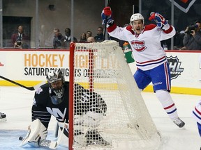 Brian Flynn of the Montreal Canadiens celebrates a first period goal by Jeff Petry  against Jaroslav Halak  of the New York Islanders at the Barclays Center on Nov. 20, 2015, in Brooklyn.