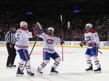 Tomas Fleischmann #15 left, Greg Pateryn #6 and Tom Gilbert #77 of the Montreal Canadiens celebrate Fleischmann's first period goal against the New York Islanders at the Barclays Center on November 20, 2015, in Brooklyn.