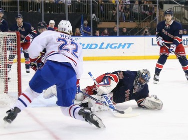 Henrik Lundqvist #30 of the New York Rangers makes the first period save on Dale Weise #22 of the Montreal Canadiens at Madison Square Garden on November 25, 2015 in New York City.