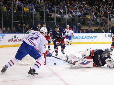 Henrik Lundqvist #30 of the New York Rangers makes the first period save on Dale Weise #22 of the Montreal Canadiens at Madison Square Garden on November 25, 2015 in New York City.