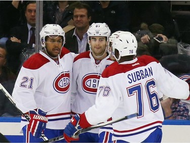 Devante Smith-Pelly #21 of the Montreal Canadiens (l) celebrates his second period goal against the New York Rangers along with Max Pacioretty #67 (c) and P.K. Subban #76 (r) at Madison Square Garden on November 25, 2015 in New York City.