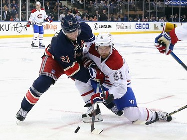 Derek Stepan #21 of the New York Rangers and David Desharnais #51 of the Montreal Canadiens battle off the faceoff during the third period at Madison Square Garden on November 25, 2015 in New York City. The Canadiens defeated the Rangers 5-1.