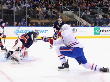 Henrik Lundqvist #30 of the New York Rangers makes the first period save on Dale Weise #22 of the Montreal Canadiens at Madison Square Garden on November 25, 2015 in New York City.