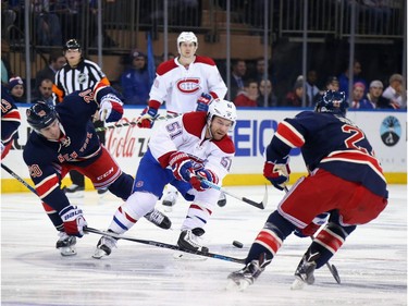 David Desharnais #51 of the Montreal Canadiens skates in on Chris Kreider #20 and Derek Stepan #21 of the New York Rangers during the first period at Madison Square Garden on November 25, 2015 in New York City.