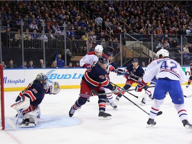 Sven Andrighetto #42 of the Montreal Canadiens (l) scores at 4:45 of the first period against Henrik Lundqvist #30 of the New York Rangers at Madison Square Garden on November 25, 2015 in New York City.