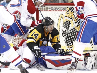 Chris Kunitz of the Pittsburgh Penguins is on top of Habs goalie Mike Condon in the first period  on Wednesday, Nov. 11, 2015 in Pittsburgh.