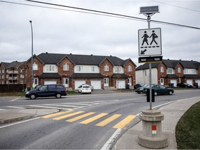 A view of the new pedestrian light installed at the intersection of Pincourt Blvd. and 5th Avenue, on Saturday November 28, 2015, in Pincourt, Quebec. The new light has a solar-panel on the post where there is a pedestrian cross sign. The panel powers special lights pedestrian can activate when they cross the street. (Giovanni Capriotti / MONTREAL GAZETTE)