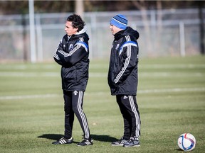 Impact's coach Mauro Biello, left, watches his players warming up at the Impact Practice Facility on Friday October 30, 2015.