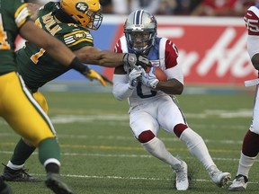 Alouettes kick returner Stefan Logan breaks a tackle by Edmonton Eskimos Mathieu Boulay during Canadian Football League game in Montreal Thursday August 13, 2015. (John Mahoney / MONTREAL GAZETTE)