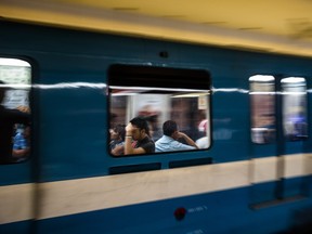MONTREAL, QUE.: AUGUST 25, 2015 -- Commuters ride the STM's orange metro line at the Henri-Bourassa metro station in Montreal on Tuesday, August 25, 2015. (Dario Ayala / Montreal Gazette)