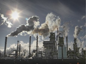 Smoke billows from stacks at the Suncor refinery in Montreal Tuesday December 02, 2014.