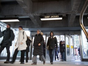 Commuters walk into Place D'Armes métro