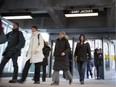 Commuters walk into Place D'Armes Metro in Montreal on February 8, 2012.