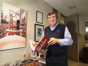 Former Canadiens GM Serge Savard poses with some of the hockey memorabilia in his Montreal office on Jan. 16, 2012.