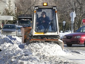 Crews clear snow on Deguire Boulevard during snow clearing operations in the borough of Ville St. Laurent in Montreal, Tuesday January 20, 2015.