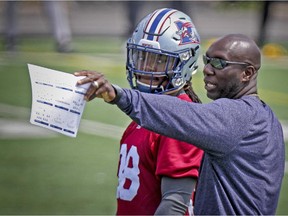 Montreal Alouettes defensive-back Dominique Ellis listens to special-teams coordinator Kavis Reed during a drill at practice at Stade Hebert in Montreal Wednesday July 08, 2015.