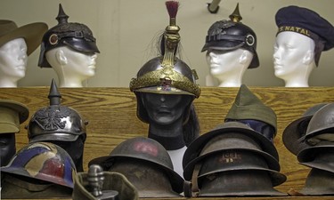 A group of helmets and hats from World War 1 on display at the Canadian Centre for the Great War, a private collection of first world war memorabilia owned by Mark Cahill, in Montreal Tuesday November 3, 2015.  The elaborate helmet in the middle is from France.