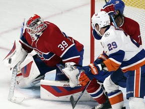 Canadiens goalie Mike Condon makes a save as teammate Tom Gilbert battles with Islanders' Anders Lee during game at the Bell Centre on Thursday, Nov. 05, 2015.