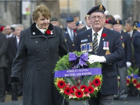 Thérèse Guérette, left, Silver Cross mother and mother of Warrant Officer Patrice Vincent who was killed in St Jean sur Richelieu, arrives to lay a wreath at a cenotaph, during a Remembrance Day ceremony at McGill University in Montreal, Wednesday November 11, 2015.
