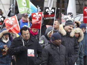 Public sector workers march along Peel Street during a demonsration in Montreal, Friday November 13, 2015,part of continuing rotating strikes across the province.