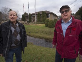 Marc-André Esculier, left, and Richard Meades, right, in front of St-Lazare town hall on Saturday, November 14, 2015. They both oppose the town's plans to borrow $10 million to demolish the current town hall building and construct a new complex on the same site. (Peter McCabe / MONTREAL GAZETTE)