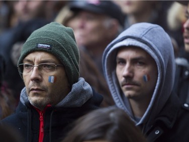 People attend a vigil outside the French consulate in Montreal Saturday, November 14 , 2015, for victims of the Paris terrorist attacks. The Islamic State group claimed responsibility for the attacks in Paris that killed 127 people Friday.